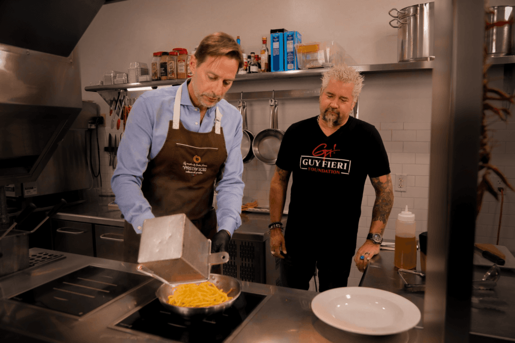Guy Fieri and Federico Perandin cooking together in the Il Pastaficio kitchen