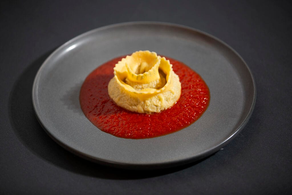 Rosetta pasta served on a pool of tomato sauce